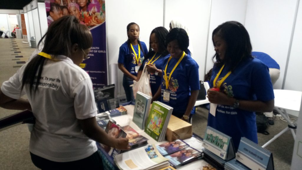 Photo 1: AHI Programme Staff engage with visitors to the AHI booth at ACSHR 2018